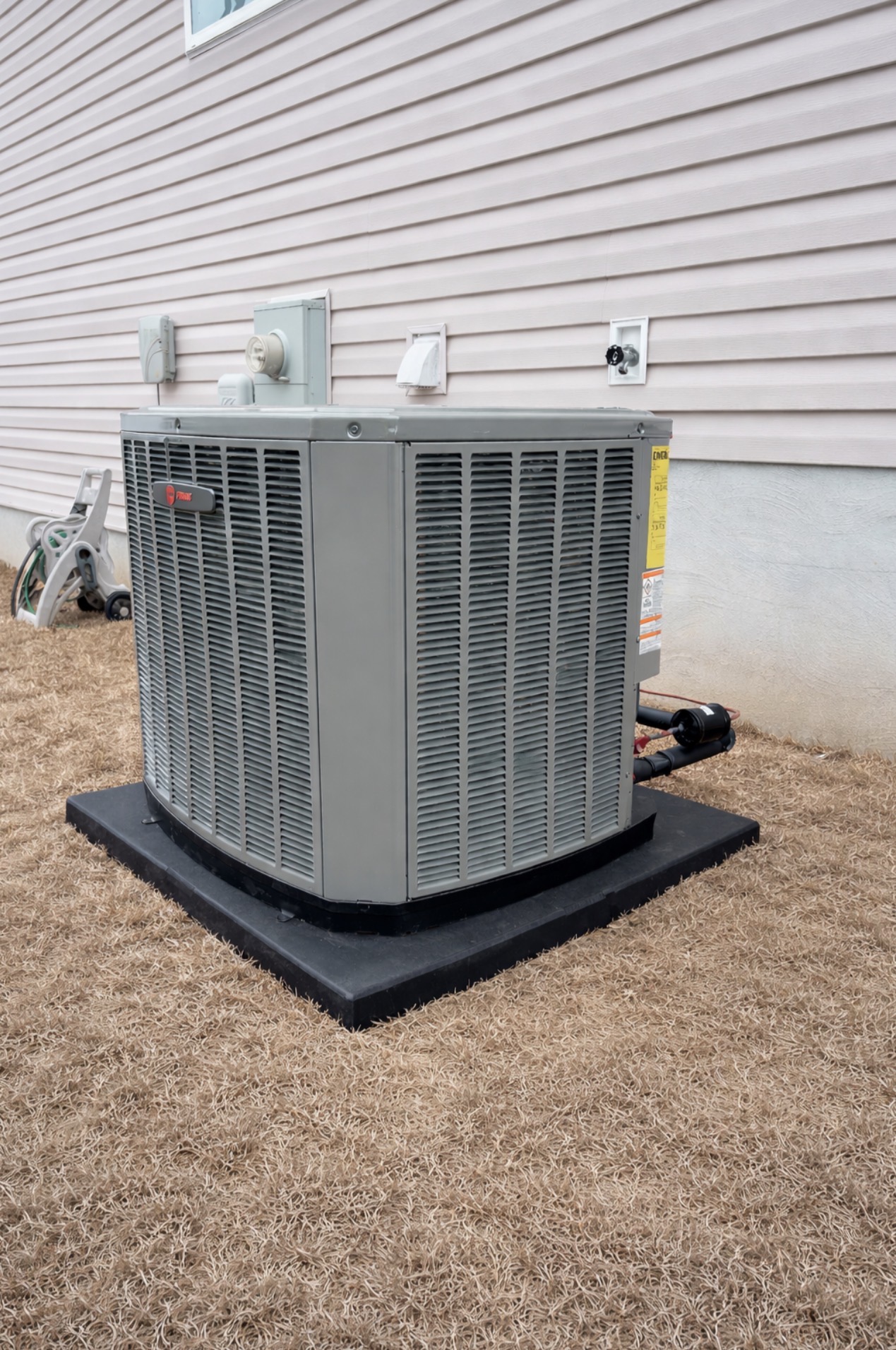 New Trane outdoor HVAC unit installed on a composite pad