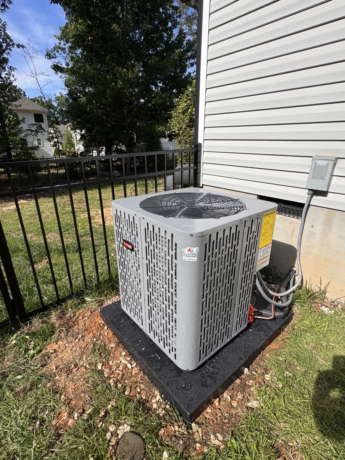 New Trane outdoor heat pump installed beside a home