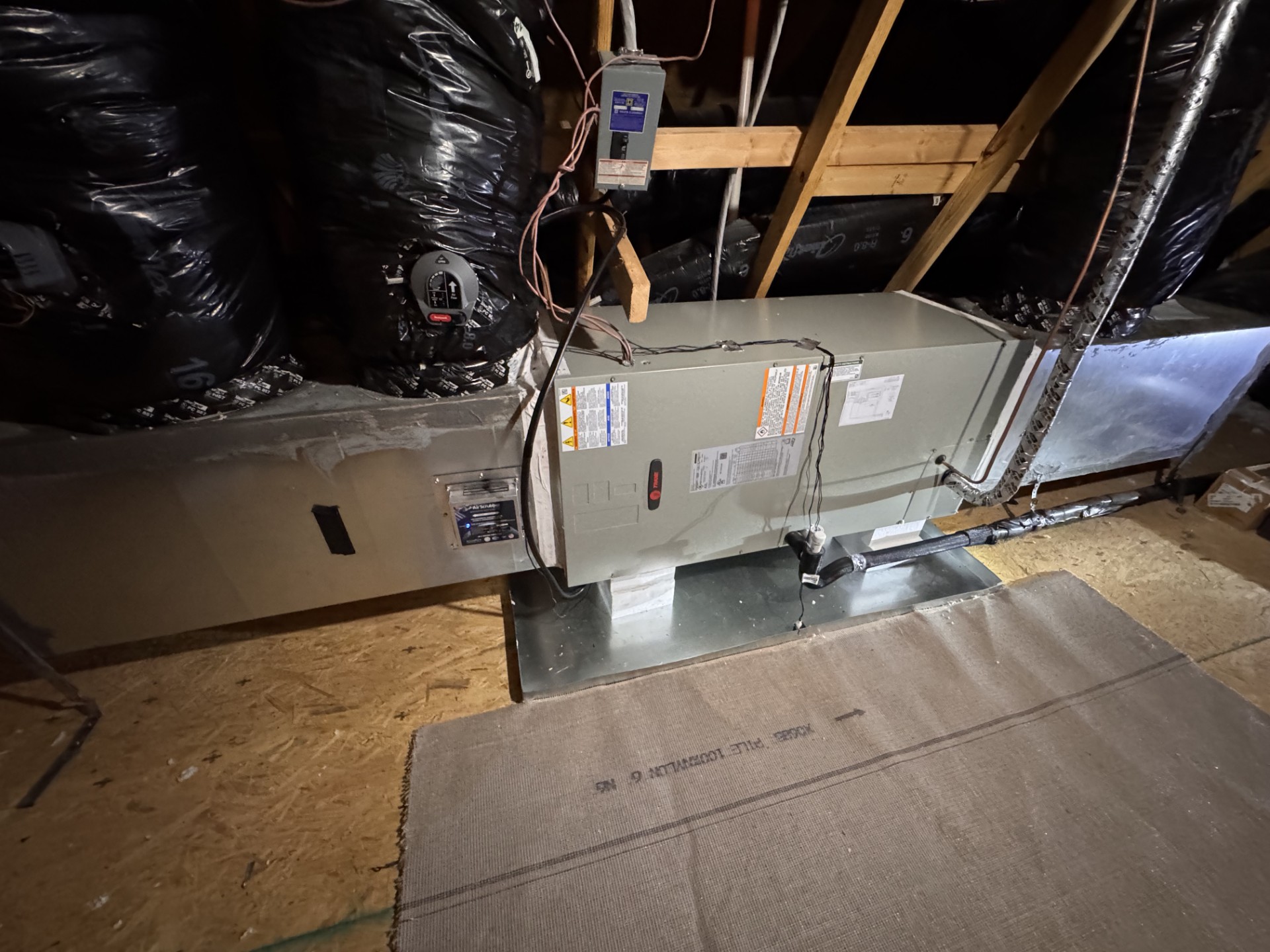 Neatly installed indoor Trane air handler and ductwork by Clayton Comfort